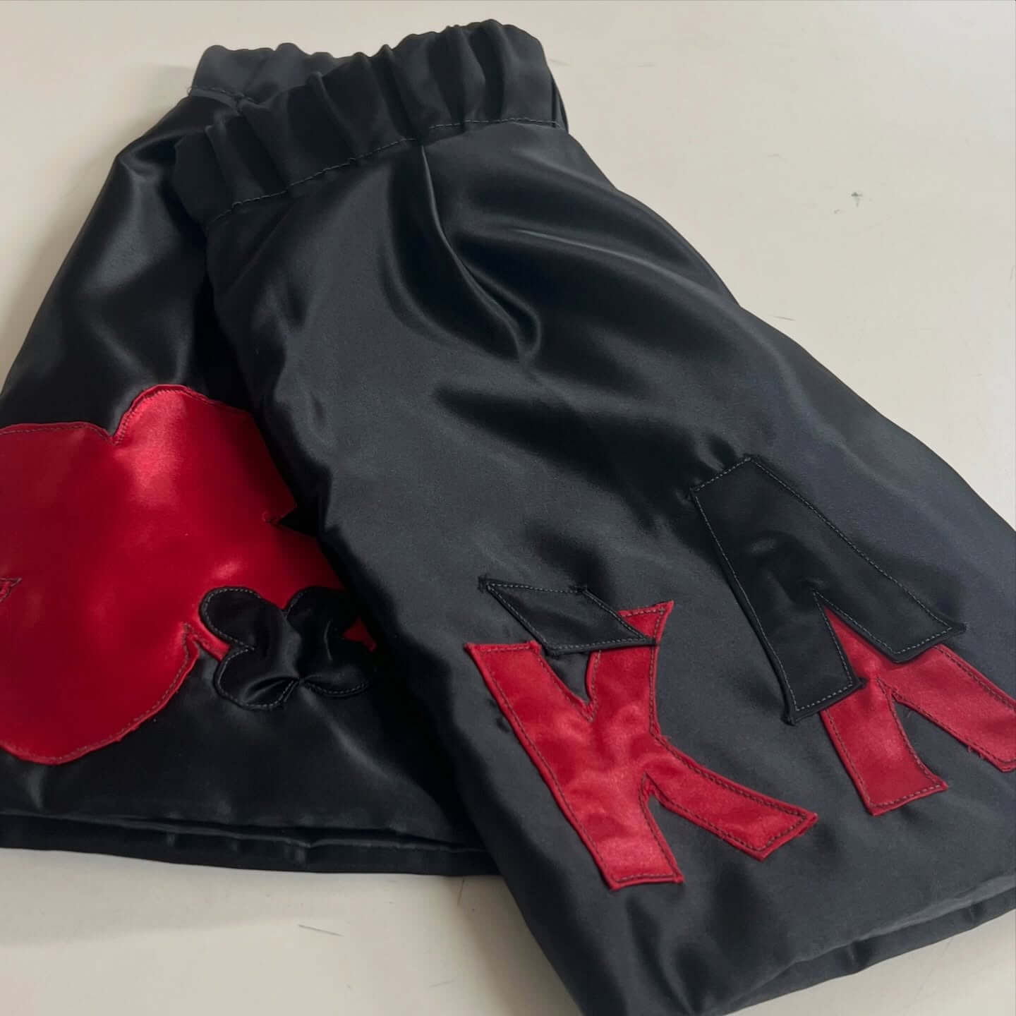 Men's Chrome Hearts inspired gothic boxing shorts black with Red hardware details Close up