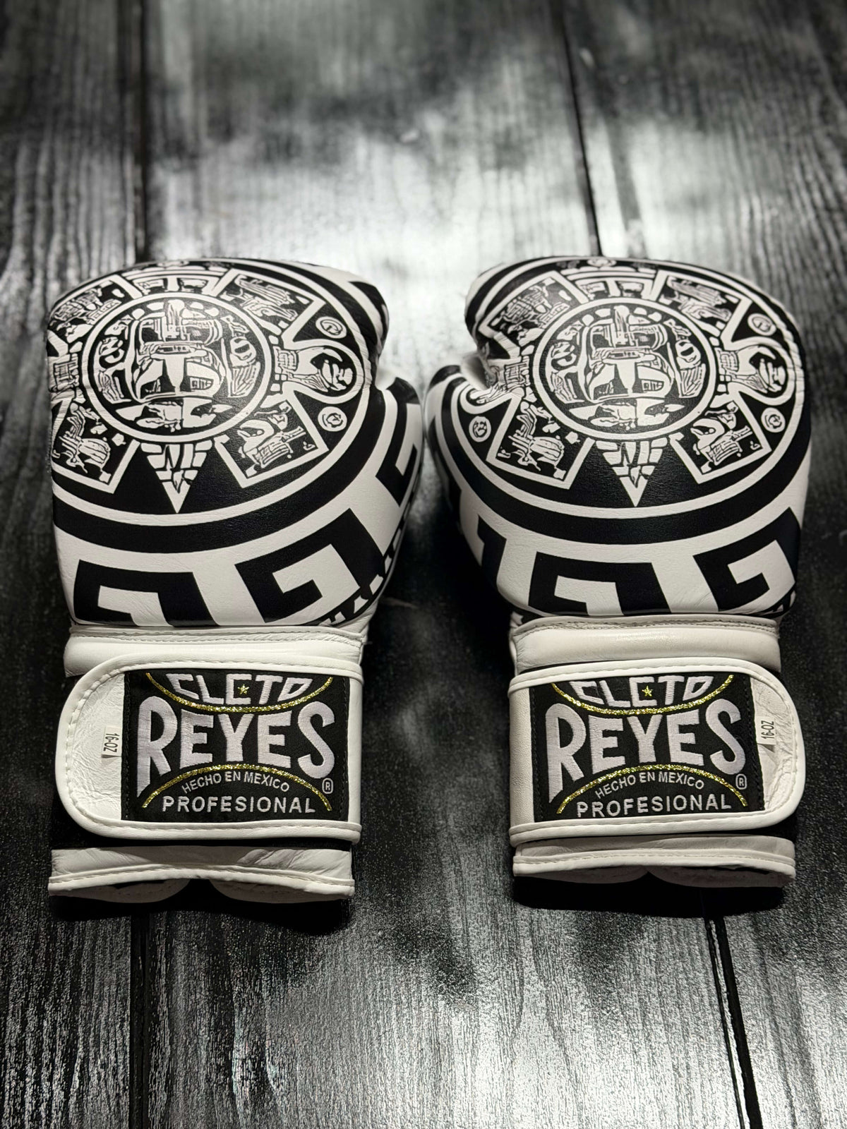 Cleto Reyes Professional boxing gloves in white featuring an intricate black Aztec calendar and tribal art design layout Back View