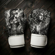 Black and white boxing gloves featuring the Greek goddess Athena with a spear, shield, and owl on one glove, and Medusa with snakes for hair and an ancient temple on the other for combat sports training.
