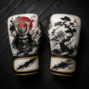 White and black boxing gloves featuring a Japanese samurai mask, red sun, Mount Fuji, and bonsai tree ink wash art design for combat sports training.