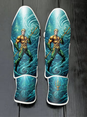 Custom Aquaman superhero design with classic orange and green suit, golden trident, underwater Atlantis ruins, swirling ocean currents, and royal crest soccer shin guards displayed on a dark surface.