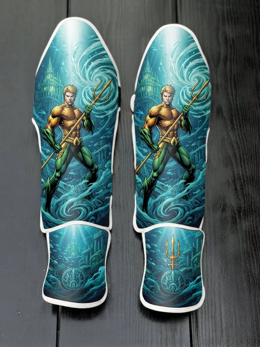 Custom Aquaman superhero design with classic orange and green suit, golden trident, underwater Atlantis ruins, swirling ocean currents, and royal crest soccer shin guards displayed on a dark surface.