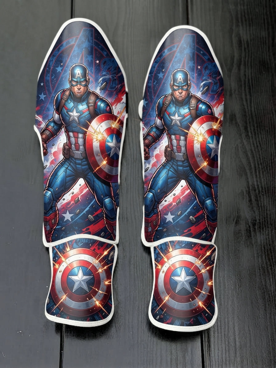 Custom Captain America superhero design with tactical blue and red uniform, vibranium shield, stars and stripes background, and exploding shield emblem soccer shin guards displayed on a dark surface.