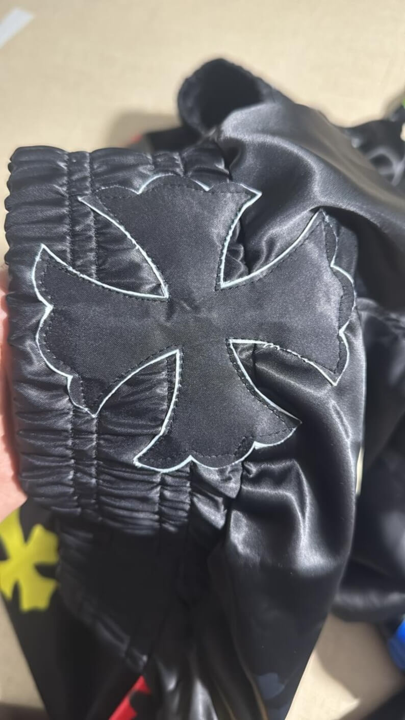 Luxury Chrome Hearts style Muay Thai shorts with ornate cross and flame design close view