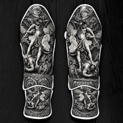 Fiest Gloves custom black-and-grey kickboxing and MMA shin guards featuring detailed baroque Renaissance artwork of Archangel Michael defeating a fallen figure, complemented by intricate floral and scrollwork patterns