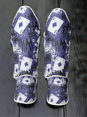 Fiest Gloves custom villain-themed kickboxing and MMA shin guards featuring a purple background, repeating "HA HA" graffiti typography, and Ace of Diamonds playing card motifs
