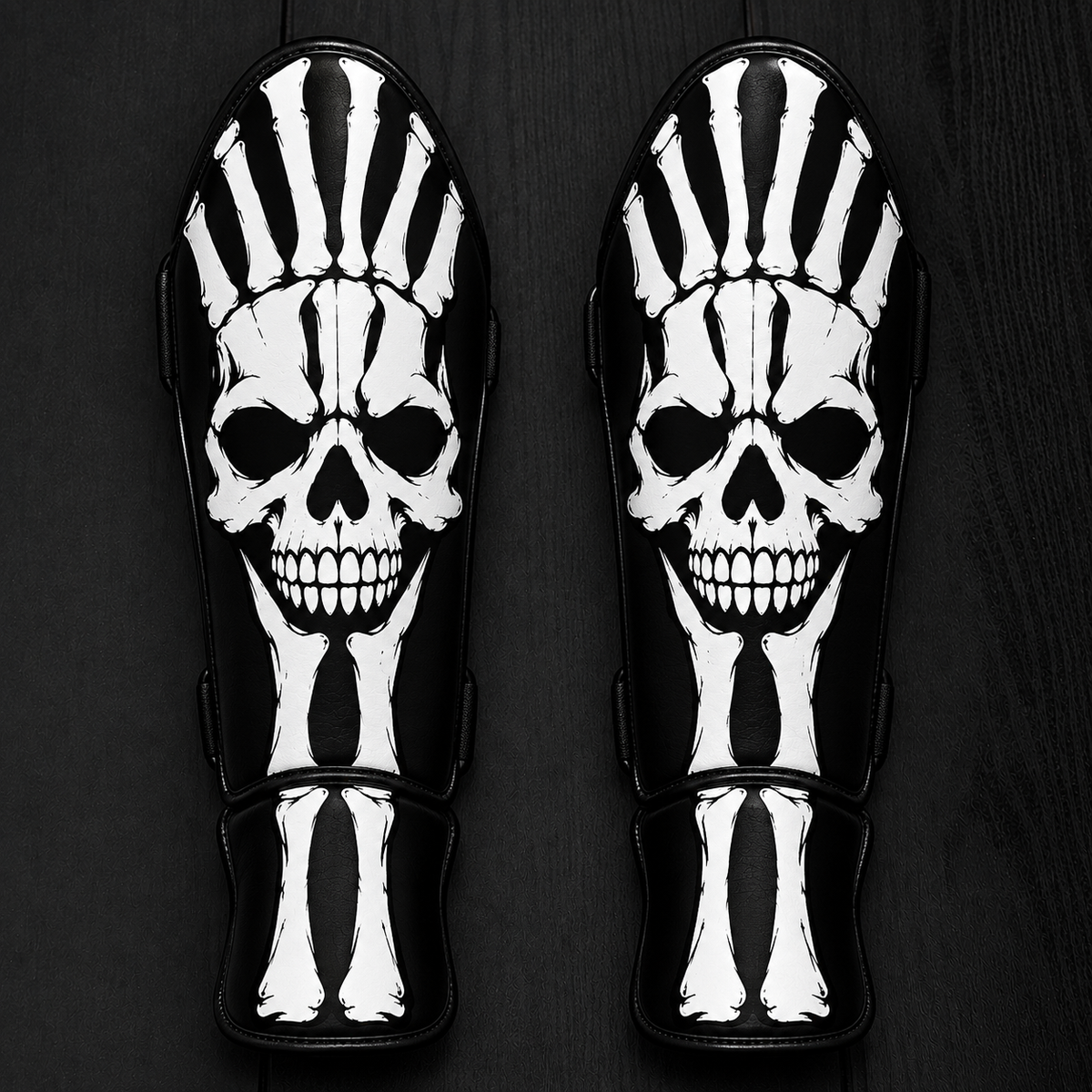 Fiest Gloves custom black-and-white kickboxing and MMA shin guards featuring a bold skeletal design with a realistic human skull graphic and matching bone structures