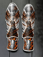 Custom Ichigo Kurosaki Soul Reaper anime design with flaming background and horned Hollow mask soccer shin guards displayed on a dark surface.