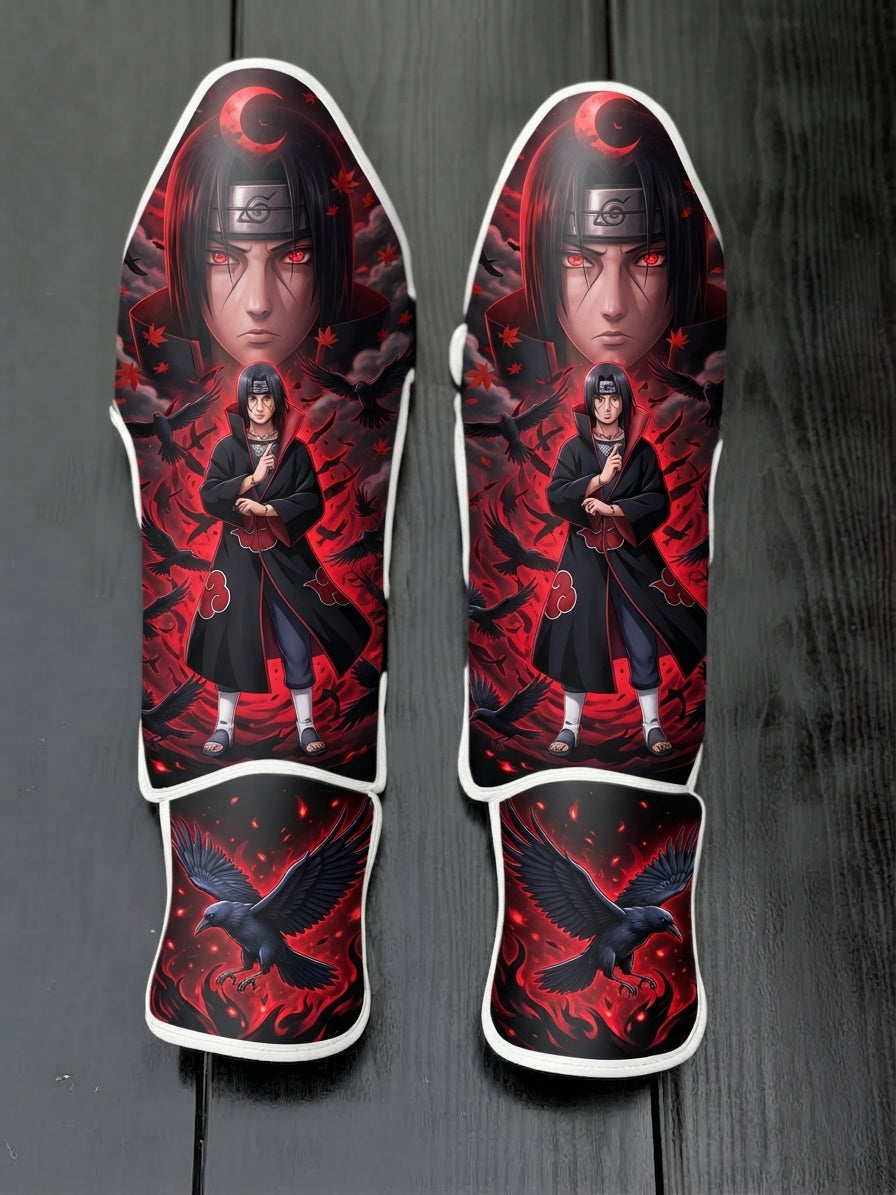 Custom Itachi Uchiha anime design with Sharingan eyes, Akatsuki cloak, and soaring black crows against a red background soccer shin guards displayed on a dark surface.