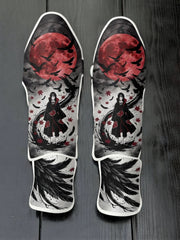 Custom Itachi Uchiha anime design with Akatsuki cloak, red full moon, and flying crows soccer shin guards displayed on a dark surface.