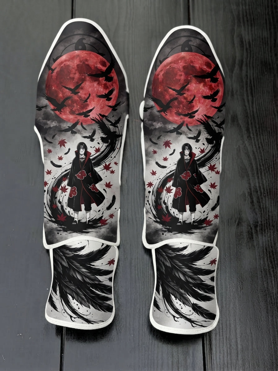 Custom Itachi Uchiha anime design with Akatsuki cloak, red full moon, and flying crows soccer shin guards displayed on a dark surface.
