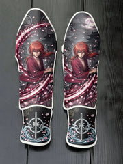 Custom Kenshin Himura anime design with red kimono, cherry blossom petals, moonlit castle background, and katana emblem soccer shin guards displayed on a dark surface.