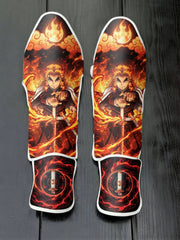 Custom Kyojuro Rengoku Flame Breathing technique anime design with blazing fire and Nichirin sword guard soccer shin guards displayed on a dark surface.