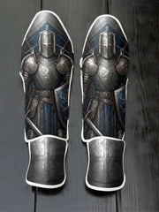 Custom medieval knight design with full steel plate armor, blue tunic, great helm, shield with lion crest, and templar cross guard soccer shin guards displayed on a dark surface.