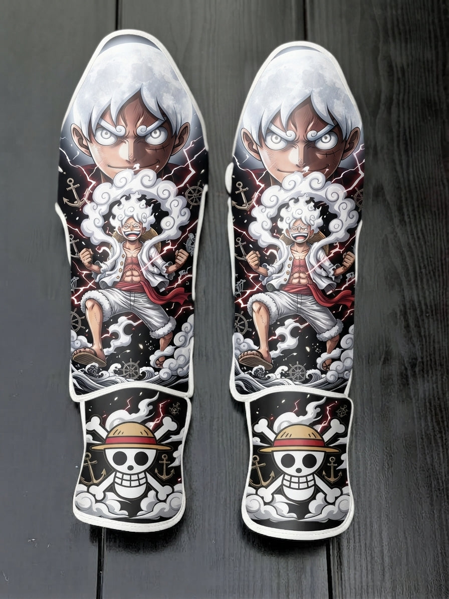 Custom Monkey D. Luffy Gear 5 awakening anime design with white hair, clouds, and straw hat skull logo soccer shin guards displayed on a dark surface.
