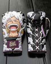 Custom boxing gloves featuring a laughing Monkey D. Luffy in One Piece Gear 5 form with white hair and smoke clouds on a dark black background, complete with a "Fiest Gloves" patch on the cuff.
