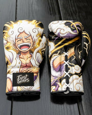 Custom boxing gloves featuring a vibrant anime design of Monkey D. Luffy in One Piece Gear 5 Sun God Nika form with white hair, gold aura, and lightning details, branded with "Fiest Gloves" on the wrist.