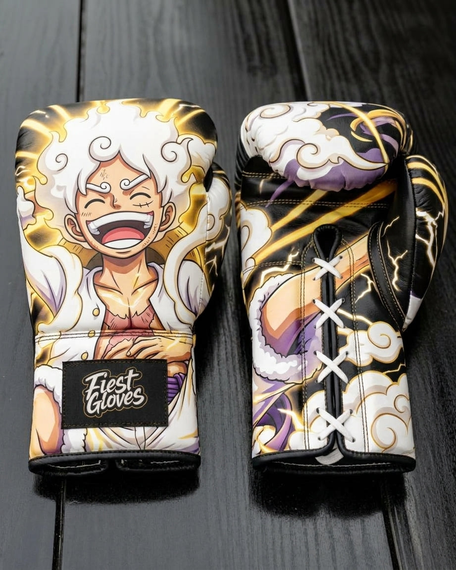 Custom boxing gloves featuring a vibrant anime design of Monkey D. Luffy in One Piece Gear 5 Sun God Nika form with white hair, gold aura, and lightning details, branded with "Fiest Gloves" on the wrist.