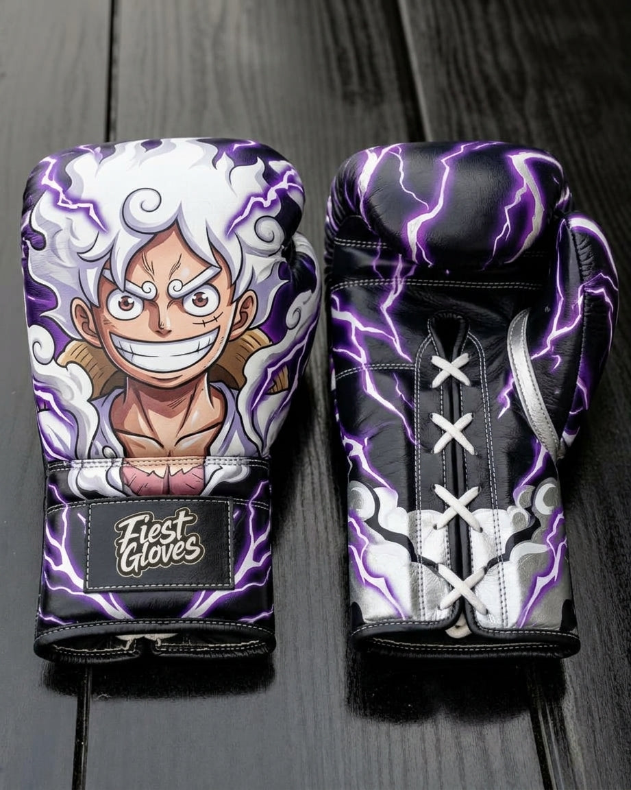 Custom boxing gloves featuring Monkey D. Luffy in One Piece Gear 5 form with white hair, intense expression, and vibrant purple lightning aura on a black background, with "Fiest Gloves" branded on the wrist cuff.