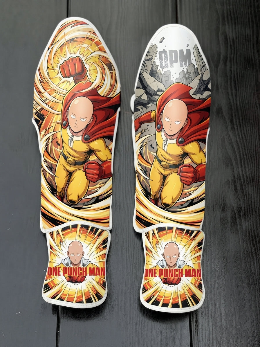 Custom Saitama One Punch Man anime design with yellow suit, red cape, swirling shockwave punch, and text banner soccer shin guards displayed on a dark surface.
