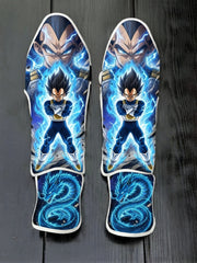 Custom Vegeta with blue energy aura and dragon motif anime soccer shin guards displayed on a dark surface.
