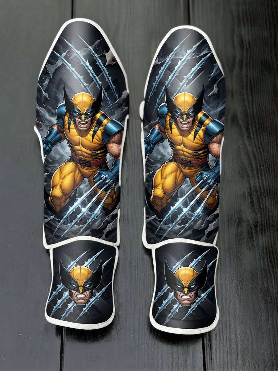 Custom Wolverine superhero design with classic yellow and blue suit, adamantium claws slashing background, and masked portrait soccer shin guards displayed on a dark surface.