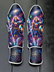 Custom Wonder Woman superhero design with cosmic armor, glowing spear, shield, nebula space background, and star compass emblem soccer shin guards displayed on a dark surface.